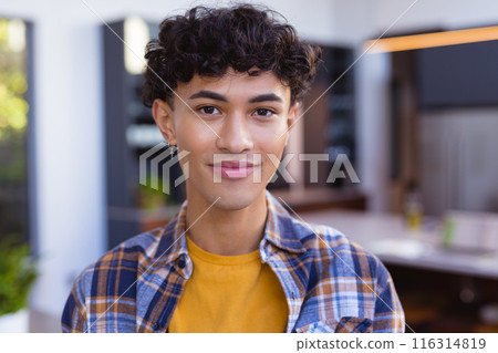 Smiling teenage boy in casual outfit at home, feeling confident Smiling teenage boy in casual outfit at home, feeling confident 116314819