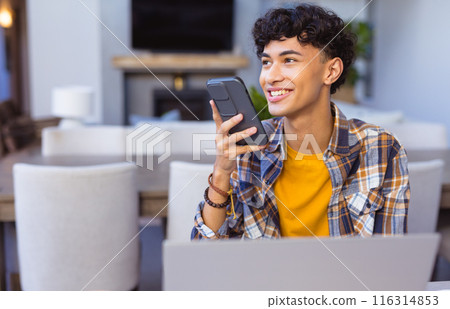 Using smartphone voice assistant and working on laptop, child smiling at home, copy space Using smartphone voice assistant and working on laptop, child smiling at home, copy space 116314853
