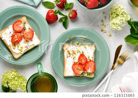 Sweet Toast with strawberry, cottage cheese and pistachios . Sandwich, Bruschetta, snack, appetizers with strawberry. top view 116315865