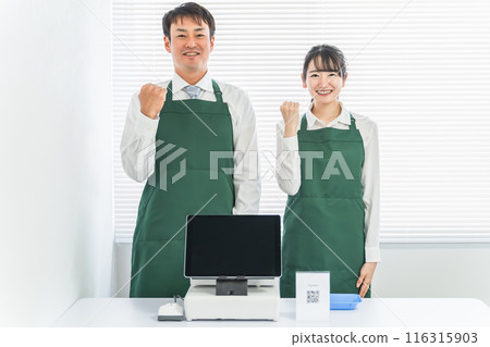 A male and female clerk who works at a cash register at a convenience store / supermarket / shop 116315903
