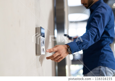 Using keycard, man accessing secure entry system of office building 116316155