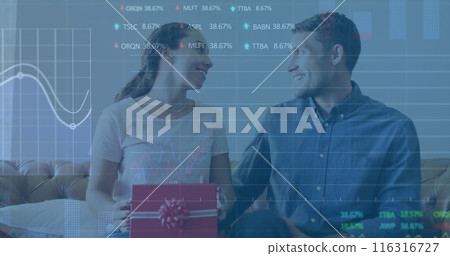 Image of graphs and trading boards, diverse man surprising woman by presenting gift at home Image of graphs and trading boards, diverse man surprising woman by presenting gift at home 116316727