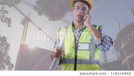 Image of building site over caucasian male worker talking on smartphone 116316848