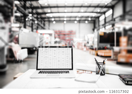 Laptop in modern industrial factory, with open software. 116317302