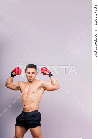 Boxing gloves, man training in sports fight, challenge or mma competition on studio background. Boxing gloves, man training in sports fight, challenge or mma competition on studio background. 116317338