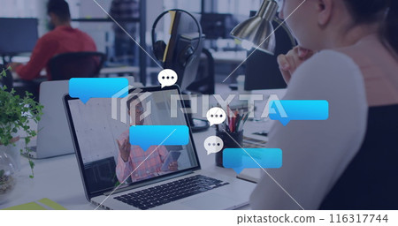 Image of message icons over caucasian woman having a image call on laptop at office 116317744