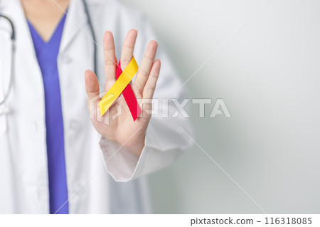 World hepatitis day awareness month, 28 July. Doctor holding Red and Yellow ribbon. Liver cancer, Jaundice, Cirrhosis, Failure, Enlarged, Hepatic Encephalopathy and Health concept 116318085