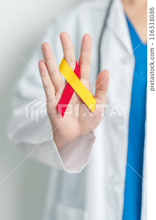 World hepatitis day awareness month, 28 July. Doctor holding Red and Yellow ribbon. Liver cancer, Jaundice, Cirrhosis, Failure, Enlarged, Hepatic Encephalopathy and Health concept 116318086