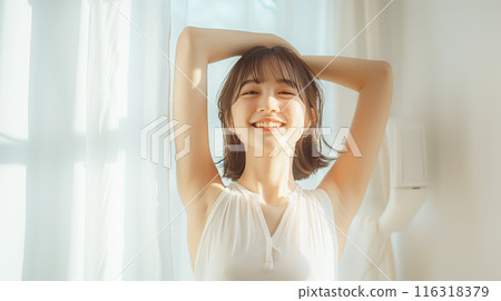 A woman stretching to wake up A woman stretching to wake up 116318379