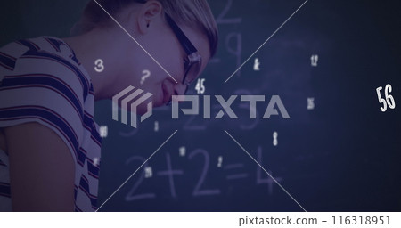 Image of numbers and symbols floating over diverse female teacher teaching a boy at school Image of numbers and symbols floating over diverse female teacher teaching a boy at school 116318951
