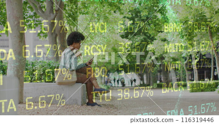 Image of african american woman sitting in park and eating food while using on cellphone Image of african american woman sitting in park and eating food while using on cellphone 116319446