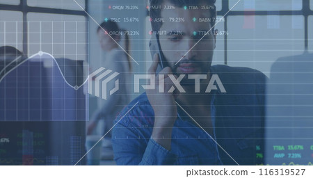 Image of stock market data processing against biracial man talking on smartphone at office Image of stock market data processing against biracial man talking on smartphone at office 116319527