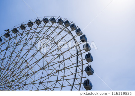 white big Ferris wheel on background a sky in amusement park white big Ferris wheel on background a sky in amusement park 116319825