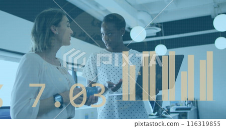 Image of statistical data processing against two diverse women discussing over laptop at office 116319855