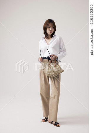 Korean Woman Poses With Sunglasses in Her Hand Korean Woman Poses With Sunglasses in Her Hand 116320396