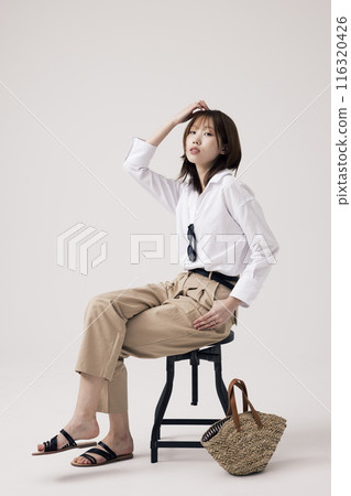 Korean Woman Poses in a Chair 116320426
