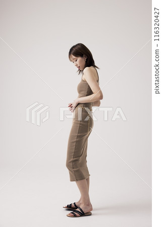 Korean Woman in Tight Beige Knit Dress Korean Woman in Tight Beige Knit Dress 116320427