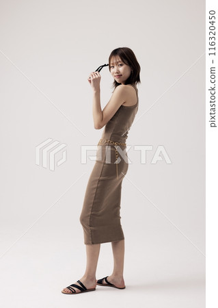 Korean Woman Wearing a Knit Dress and Holding a Sundlas 116320450