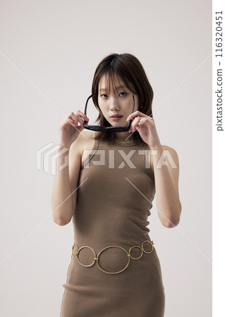 Korean Woman Wearing a Knit Dress and Holding a Sundlas 116320451