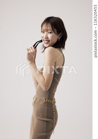 Korean Woman Wearing a Knit Dress and Holding a Sundlas 116320455