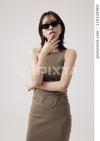 Korean Woman Wearing a Knit Dress and Sundlas 116320460