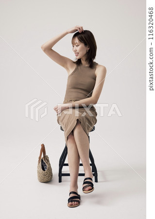 Korean Woman Poses in a Chair 116320468