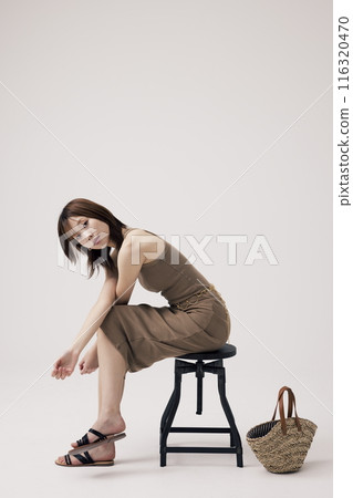 Korean Woman Poses Sitting on a Chair Korean Woman Poses Sitting on a Chair 116320470