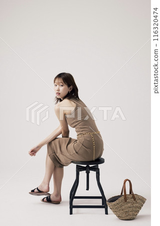 Korean Woman Poses Sitting on a Chair Korean Woman Poses Sitting on a Chair 116320474