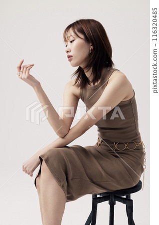 Korean Woman Poses in a Chair in Beige Knit Dress 116320485
