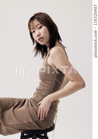 Korean Woman Poses Sitting on a Chair Korean Woman Poses Sitting on a Chair 116320487