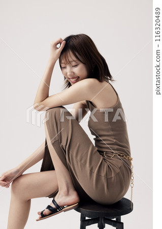 Korean Woman Poses Sitting on a Chair 116320489