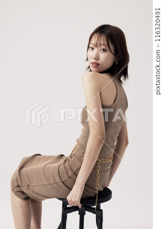 Korean Woman Poses Sitting on a Chair 116320491
