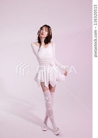 A Korean woman in her 20s posing in a white ballet core look with a light pink background A Korean woman in her 20s posing in a white ballet core look with a light pink background 116320515