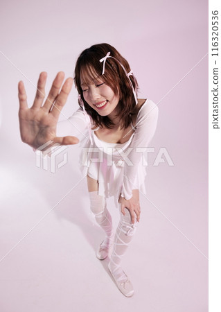 A Korean woman in her 20s who wears a ballet core look and bends her body and shows her palms A Korean woman in her 20s who wears a ballet core look and bends her body and shows her palms 116320536