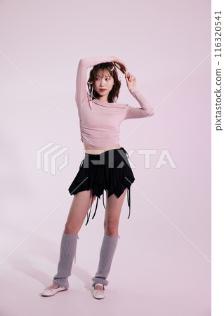 a Korean woman in her 20s posing while wearing a pink top and a black wrap skirt a Korean woman in her 20s posing while wearing a pink top and a black wrap skirt 116320541
