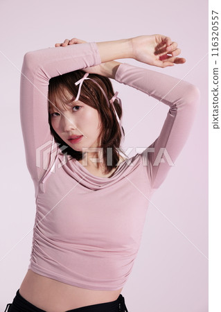 A Korean woman in her 20s wearing a pink top and a hair ribbon A Korean woman in her 20s wearing a pink top and a hair ribbon 116320557