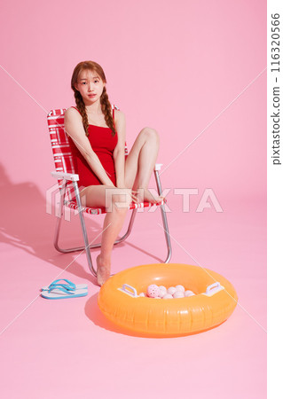 Korean woman in her 20s posing in a chair wearing a monokini look 116320566