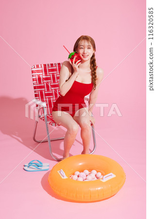 A Korean woman in her 20s who sits on a chair wearing a monokini look and drinks A Korean woman in her 20s who sits on a chair wearing a monokini look and drinks 116320585