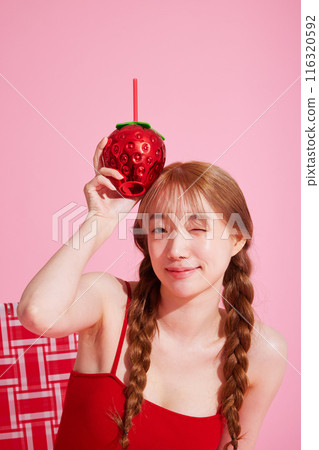 A Korean woman in her 20s who winks with a drink wearing a monokini look 116320592