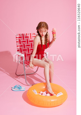 Korean Woman in Her 20s Poses With Ice Cream in Monokini Look 116320640