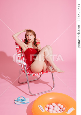 Korean woman in her 20s posing in a chair wearing a monokini look 116320654