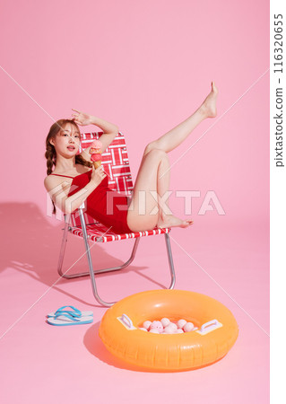 Korean woman in her 20s posing in a chair wearing a monokini look 116320655