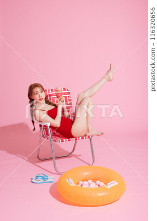 Korean woman in her 20s posing in a chair wearing a monokini look Korean woman in her 20s posing in a chair wearing a monokini look 116320656