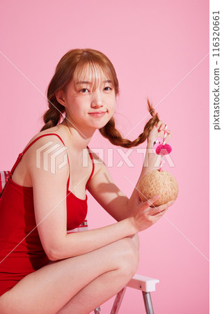 A Korean Woman in Her 20s Wearing a Monokini Look and Holding a Coconut Drink A Korean Woman in Her 20s Wearing a Monokini Look and Holding a Coconut Drink 116320661