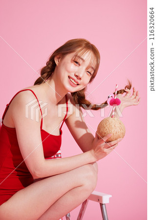 A Korean Woman in Her 20s Wearing a Monokini Look and Holding a Coconut Drink A Korean Woman in Her 20s Wearing a Monokini Look and Holding a Coconut Drink 116320664