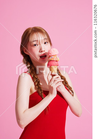 A Korean woman in her 20s wearing a monokini look with a pink background and holding an ice cream 116320676