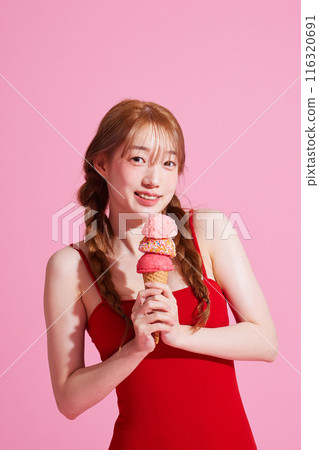 A Korean woman in her 20s holding an ice cream in a pink background A Korean woman in her 20s holding an ice cream in a pink background 116320691