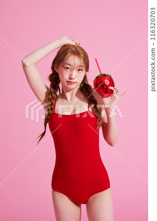 Korean woman in her 20s posing in a monokini look with a pink background 116320703