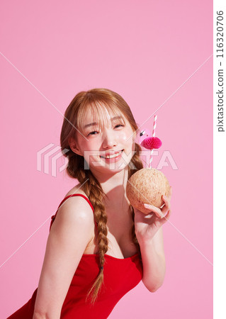 A Korean Woman in Her 20s Wearing a Monokini Look and Holding a Coconut Beverage 116320706