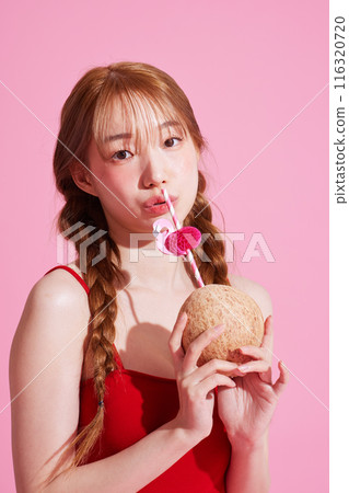A Korean Woman in Her 20s Holding a Coconut Drink A Korean Woman in Her 20s Holding a Coconut Drink 116320720